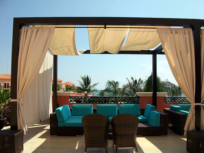 Luxury Outdoor Patio with Turquoise Sofa and Ocean View