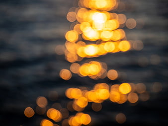 Golden Sunlight Bokeh Reflections on Blurred Ocean Water