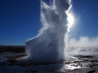 Strokkur Geyser Erupting in Iceland with Sun Flare
