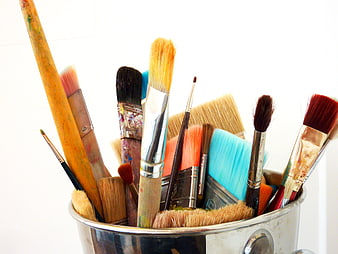 Assorted Multicolored Paint Brushes In Metal Container