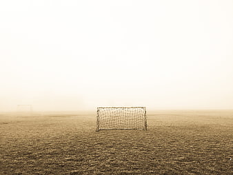 Foggy Soccer Field With Goal Post In Sepia Tone
