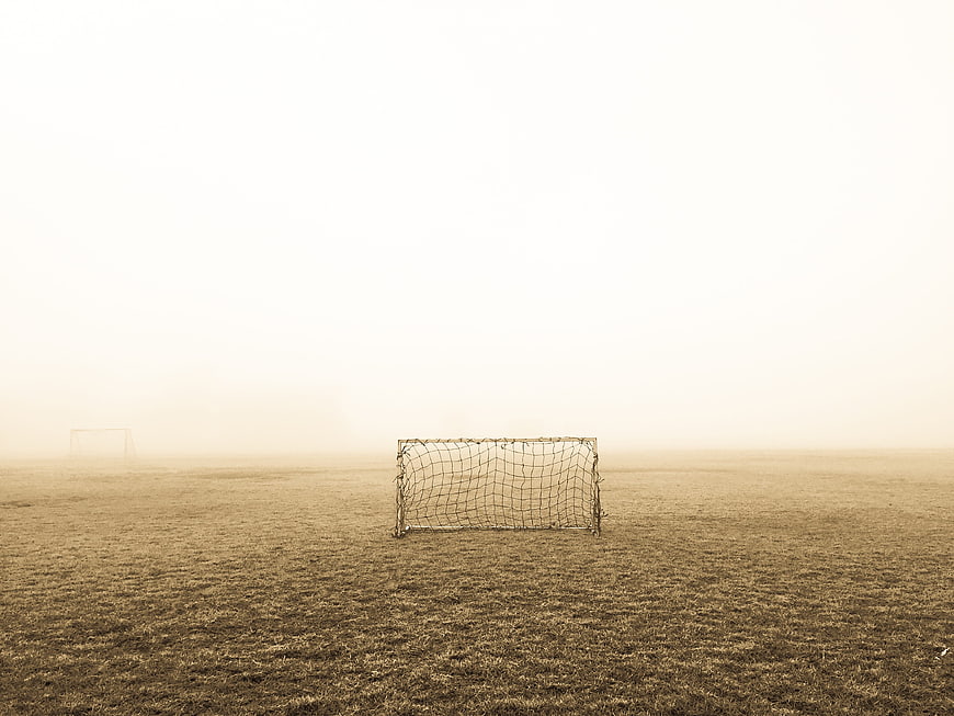 Foggy Soccer Field With Goal Post In Sepia Tone
