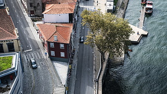 Aerial View of Riverside Street with Red Roofs and Boats