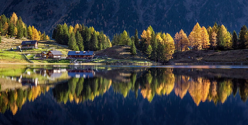 Alpine Mountain Lake With Autumn Reflections And Chalets