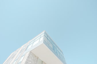Modern white building corner against clear blue sky