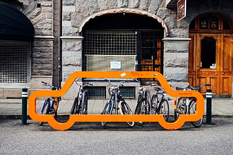 Orange Car-Shaped Bike Rack on Urban Street