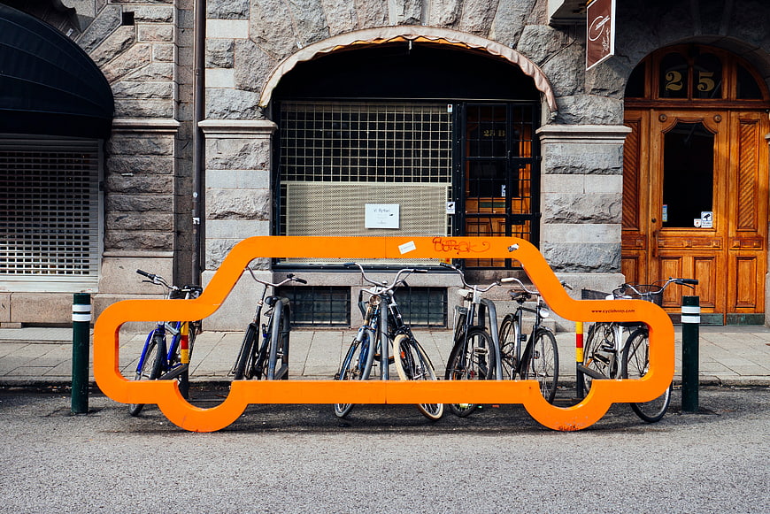 Orange Car-Shaped Bike Rack on Urban Street