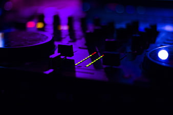 DJ Mixer with LED Levels in Dark Club Atmosphere