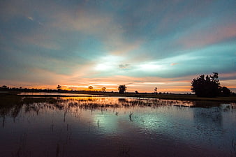 Serene Sunset Reflection Over Marshland Water