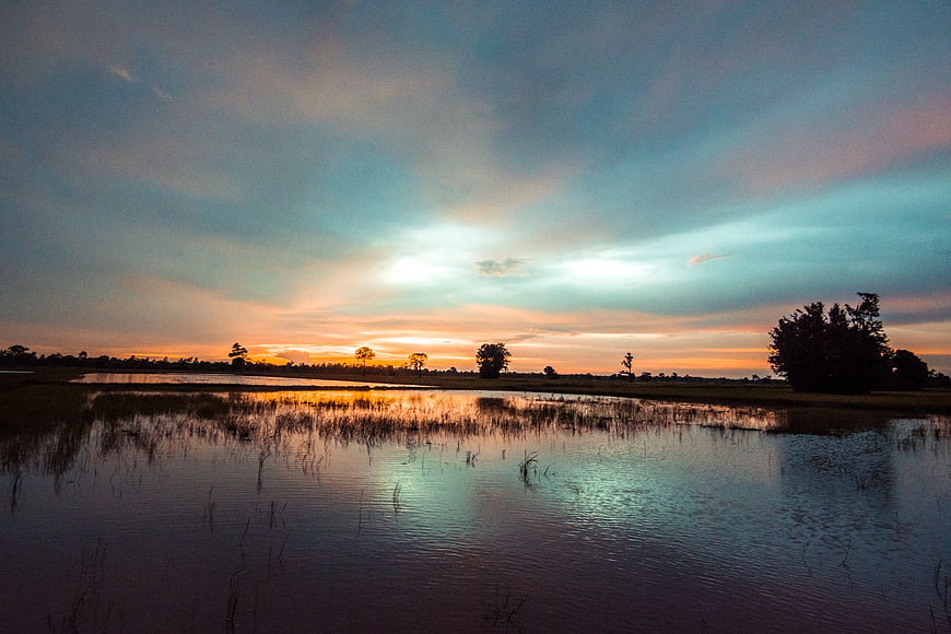Serene Sunset Reflection Over Marshland Water