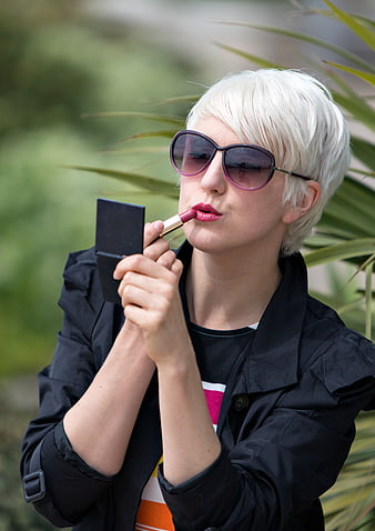 Blonde Woman Applying Lipstick With Mirror And Sunglasses