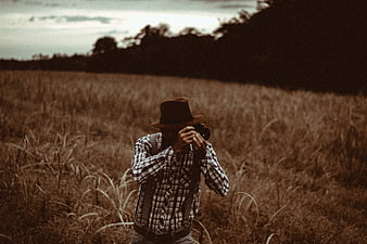 Man with Camera in Sepia Field