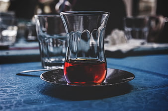Traditional Turkish Tea Glass on Blue Tablecloth