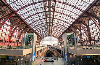 Grand arched glass roof of a historic European train station interior