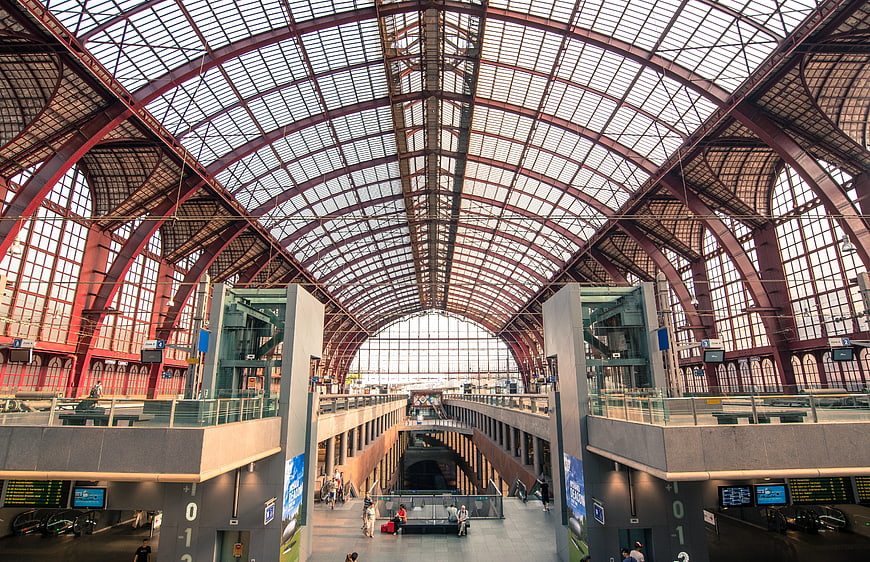Grand arched glass roof of a historic European train station interior