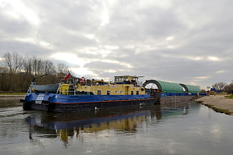 Blue and yellow cargo barge on a river