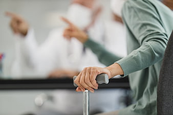 Senior Patient Hand on Cane in Doctor's Office