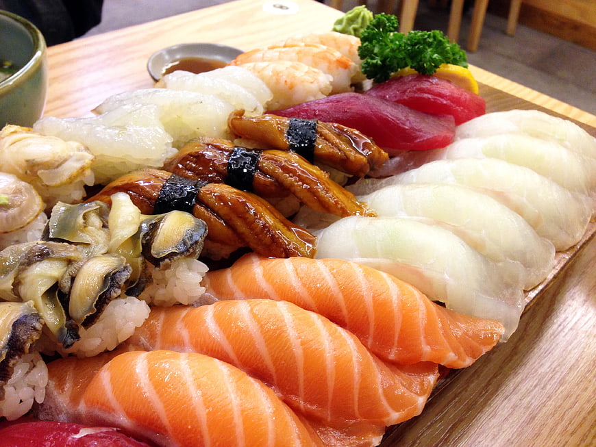 Assorted Sushi Platter with Salmon, Eel, and Tuna on Wooden Board