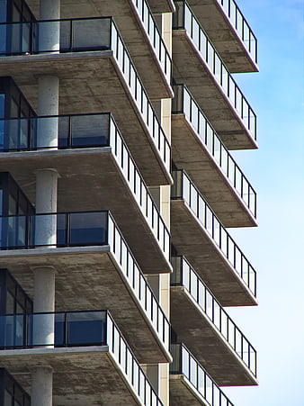 Modern Concrete Apartment Building Balconies Against Blue Sky