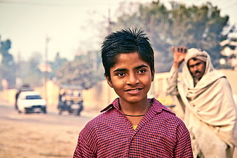 Portrait of smiling Indian boy on rural road
