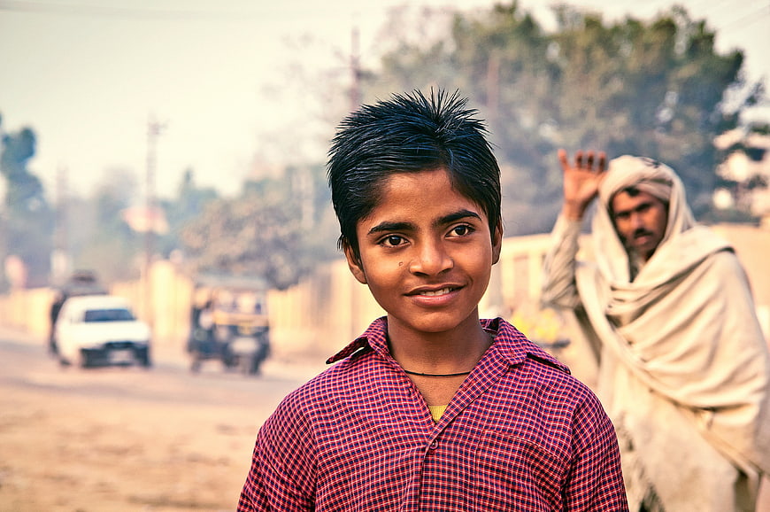 Portrait of smiling Indian boy on rural road