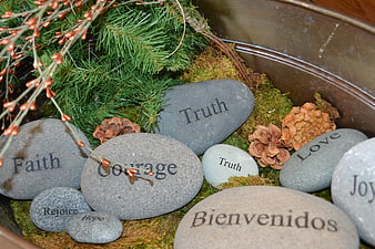 Inspirational engraved stones with words like faith, courage, and love