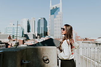 Woman in Sunglasses on Rooftop with Nashville Skyline