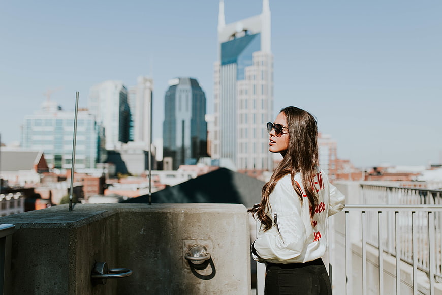 Woman in Sunglasses on Rooftop with Nashville Skyline