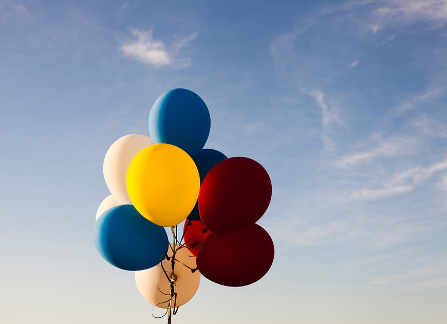 Colorful Balloons Floating Against Blue Sky