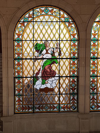 Stained Glass Window Depicting Lady Justice with Scales and Sword