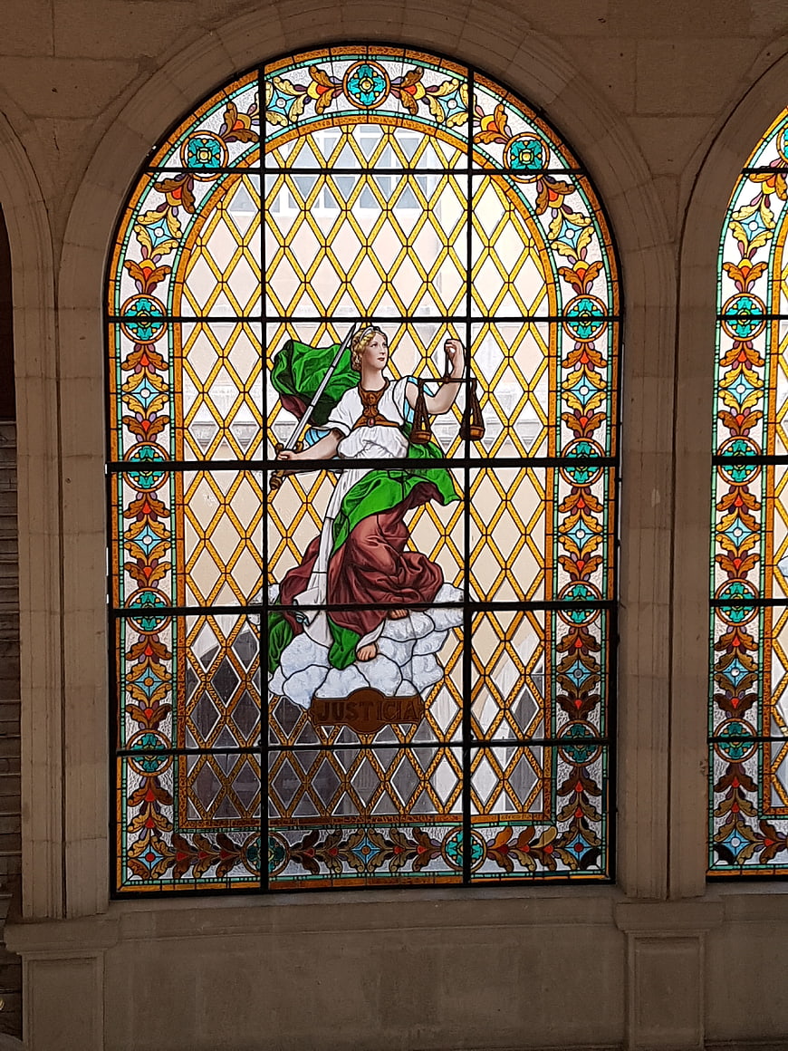 Stained Glass Window Depicting Lady Justice with Scales and Sword
