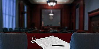 Divorce Agreement and Wedding Rings on Courtroom Table