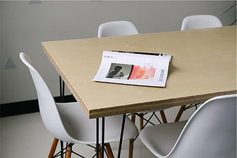 Modern office table with magazine and white chairs