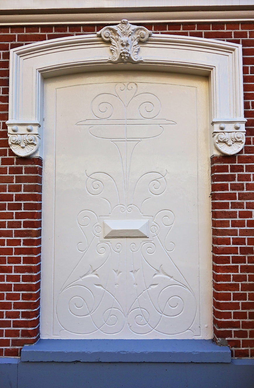 Ornate White Blind Door on Red Brick Wall