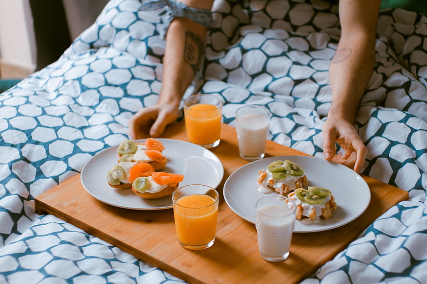 Breakfast in bed for a couple with juice and pastries