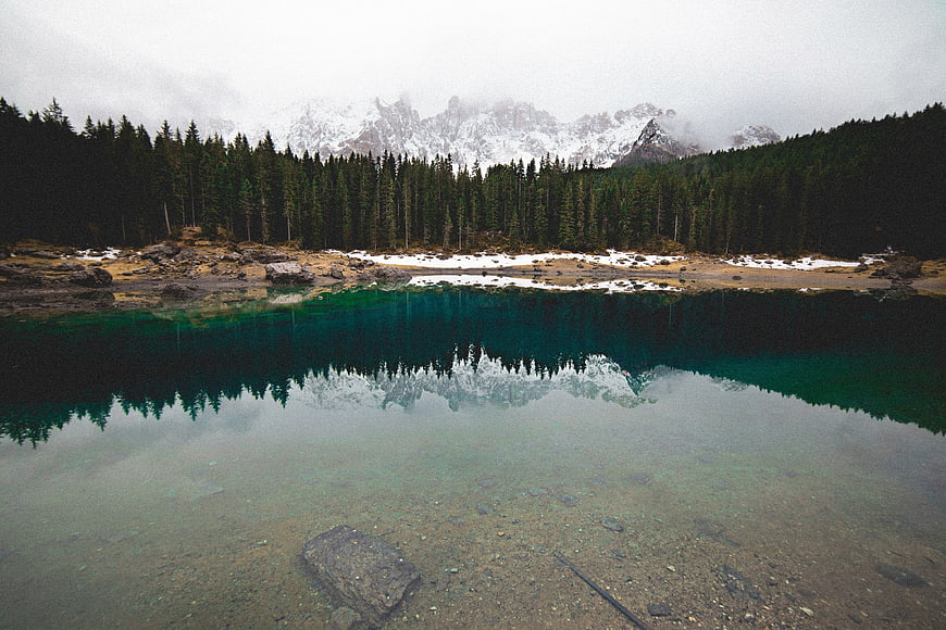 Serene Alpine Lake with Mountain Reflection and Pine Forest