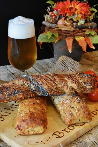 Artisan Bread Loaves and Beer on Wooden Board