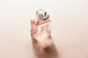Pink Perfume Bottle on Soft Beige Background