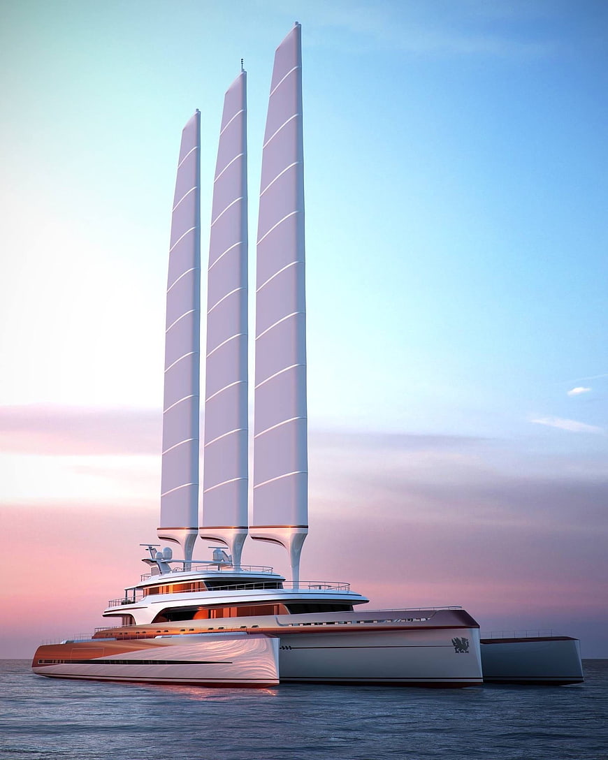 Futuristic white trimaran superyacht with three tall sails on calm ocean at sunset
