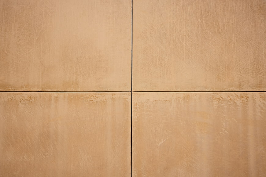 Beige textured wall tiles with geometric grid pattern background
