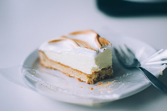 Slice of Cheesecake with Meringue Topping on White Plate