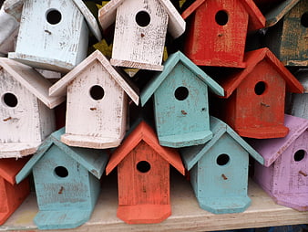 Colorful Weathered Wooden Birdhouses Stacked On A Shelf