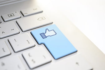Blue Thumbs Up Key On White Laptop Keyboard