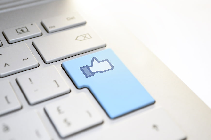 Blue Thumbs Up Key On White Laptop Keyboard