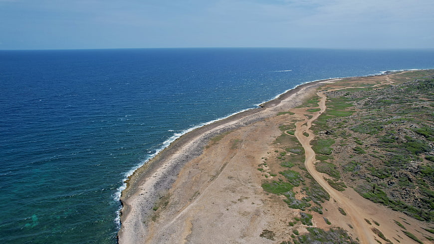 Aerial View of Rugged Coastal Cliff and Blue Ocean