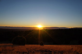 Golden Sunset Over Silhouetted Mountain Landscape
