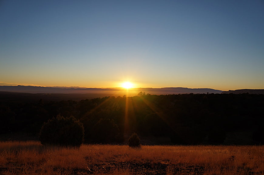 Golden Sunset Over Silhouetted Mountain Landscape
