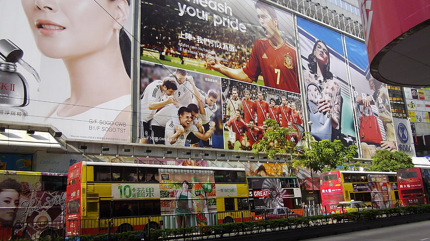 Hong Kong street scene with double-decker buses and large billboards