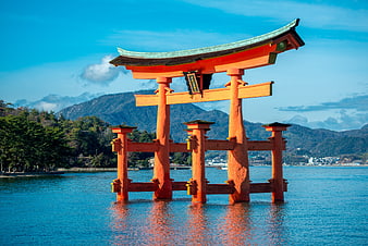 Floating red torii gate in the water with mountains