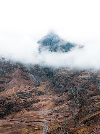 Misty Mountain Peak with Winding Road in Valley